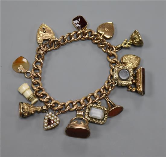 A 9ct gold charm bracelet hung with twelve assorted charms, gross 43 grams.